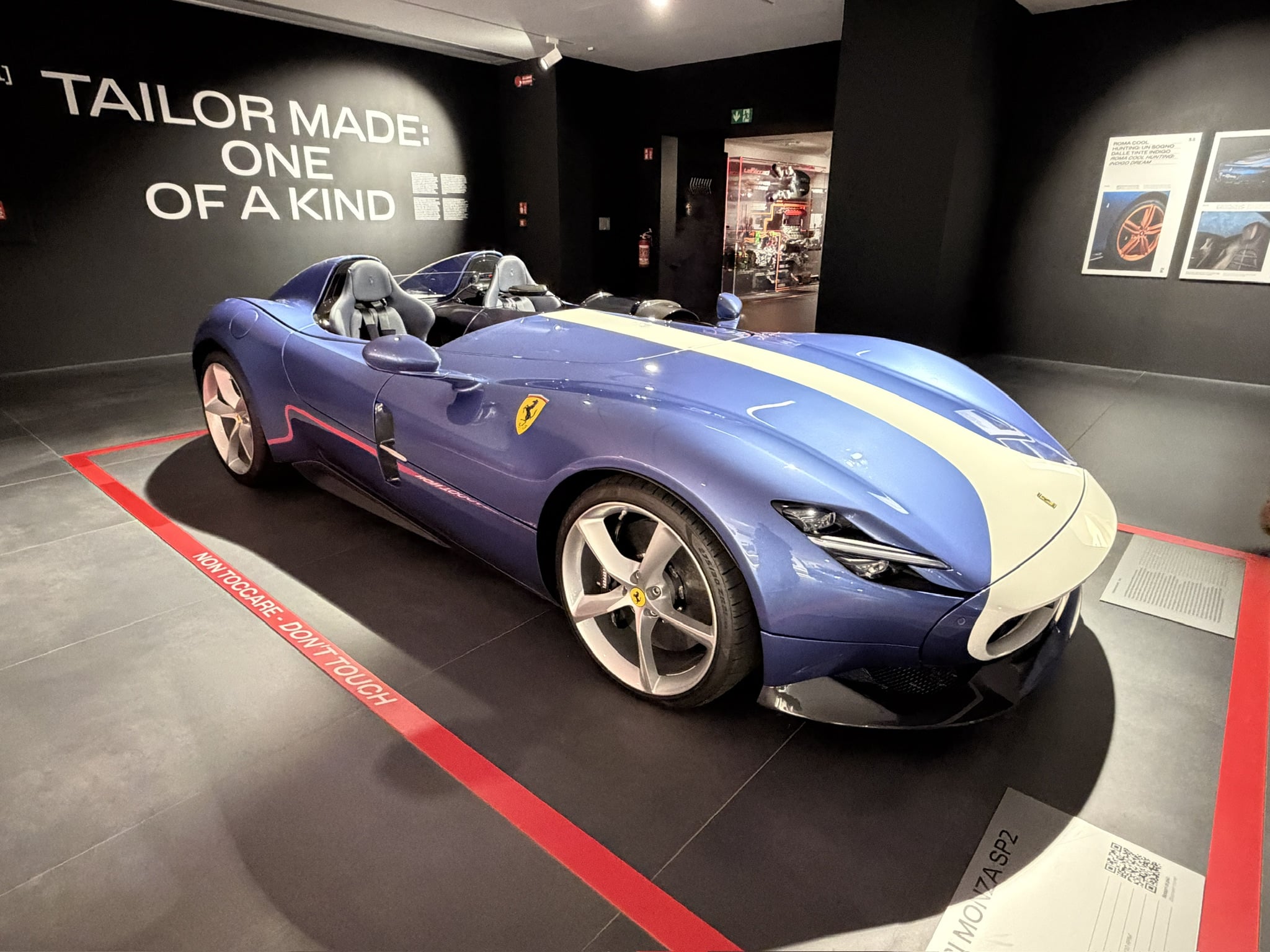 A stunning blue Ferrari Monza SP2 speedster showcases tailor made craftsmanship in this sleek museum display
