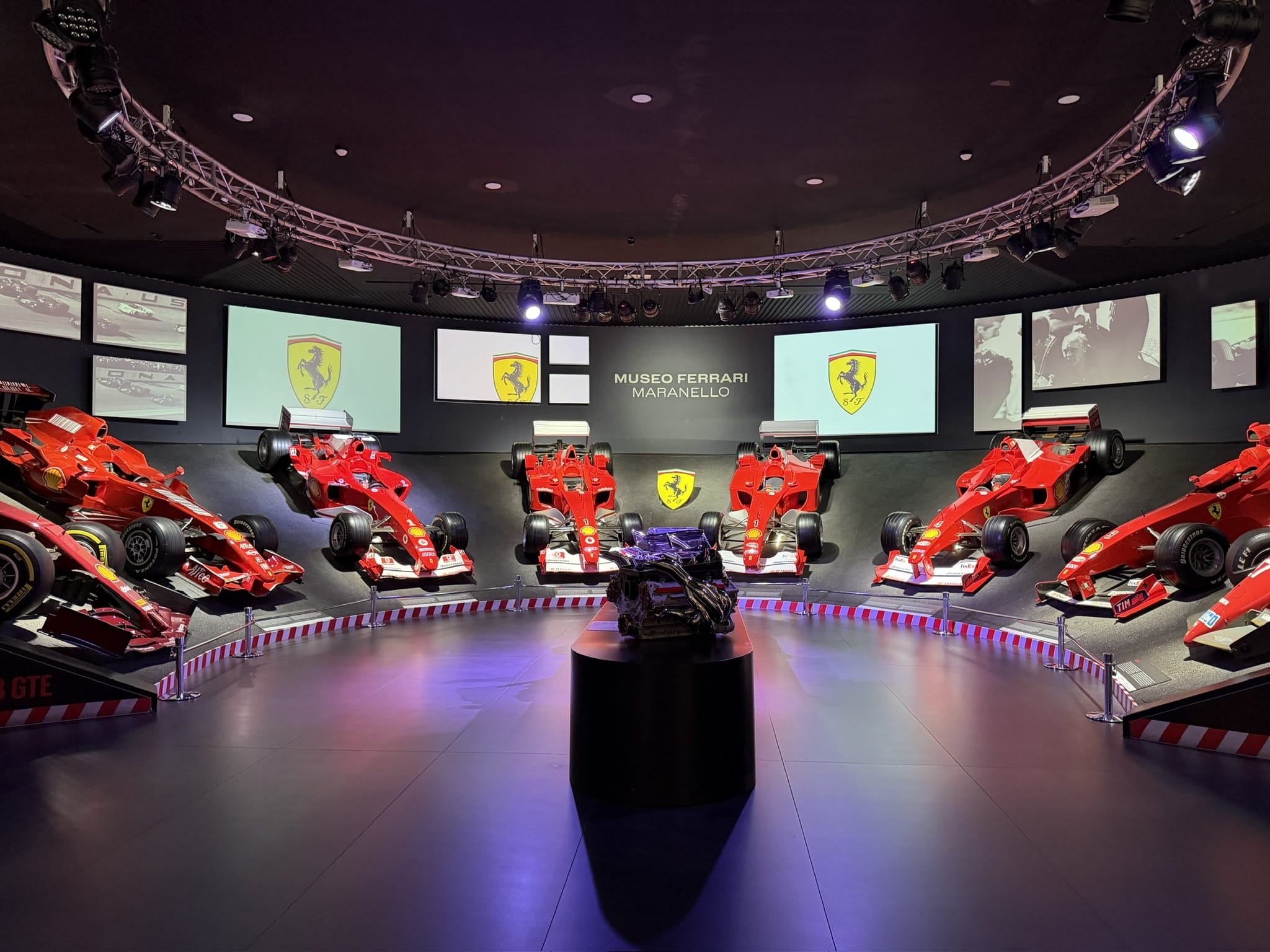 Ferrari Formula 1 cars surround a championship trophy display at the Museo Ferrari in Maranello