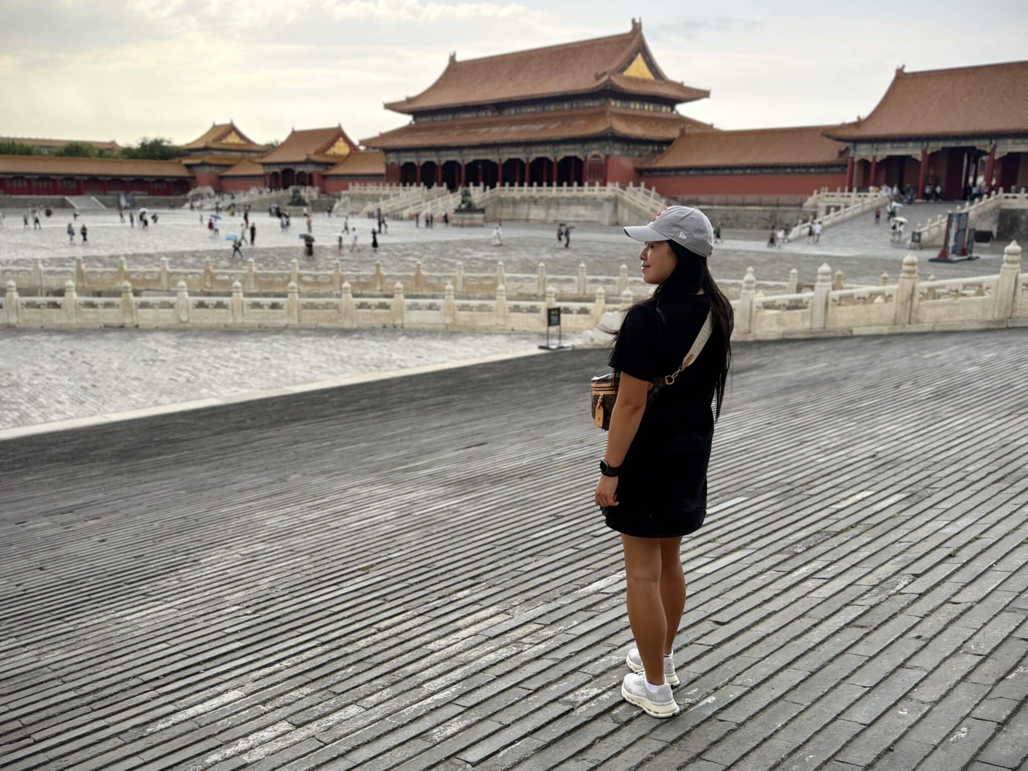 A visitor admires the magnificent traditional architecture of Beijing's Forbidden City from the grand courtyard